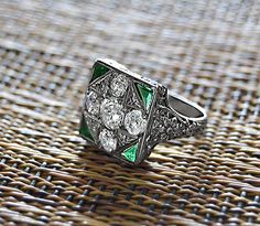 Classic Art Deco 18k White Gold DIAMOND & EMERALD RING size 5 Lady's Art Deco White Gold and European Cut Diamond and Calibrated Emerald Triangles (5) Square Ring. This Ring contains (5) Graduated Old European Cut Diamonds ... Measuring approximately: 4-4.25 X 2.50mm (1)- 5.76 X 3.40mm Weight: approximately 1.82 Carats Total Color: G-H Clarity: VS2 (4)- Natural Calibrated Triangular, Faceted, Green Emerald Measuring approximately: 4.80 X 2.48 X 1.7mm each Weight: approximately .28 Carats Tot Green Art Deco Diamond Ring With Diamond Cut, Art Deco White Gold Cluster Ring With 17 Jewels, Luxury Diamond Cut Collectible Rings, Luxury Collectible Diamond Cut Rings, Art Deco Green Ring With Diamond Accents, Green Art Deco Rings With Diamond Accents, Collectible Single Cut Diamond Rings In Fine Jewelry, Art Deco White Gold Emerald Ring With Diamond Cut, Collectible Single Cut Diamond Rings