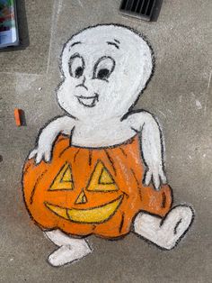 a chalk drawing of a ghost holding a pumpkin