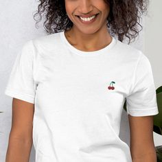 This is our Embroidered Cherry T-Shirt. A T-shirt that has a minimalistic Scandinavian design with an embroidered print that will show the world what you love in a subtle but classy way.  The T-shirt feels soft and light with just the right amount of stretch. It's comfortable and flattering for all. This shirt is available in a range of unisex sizes from XS to 2XL making it suitable for any body type. To be sure of your size, please refer to our size chart from the manufacturer in the listing ph Scandinavian Style, Scandinavian Design, Polyester Fabric, Fabric Weights, Favorite Outfit, Gender Neutral, Art Collection, Bathing Beauties, Tops & Tees