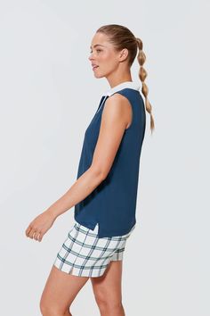 Tnuck Sport combines technical fabrics with stylish silhouettes to move with you as you play all day. From morning coffee runs to marathons, our founders designed these everyday active pieces for an on-the-go but always on-trend lifestyle.A classic look with modern tailoring, the Navy Sleeveless Polo is our definition of clubhouse cool. Featuring a flat knit collar that aids in sun protection on the back of your neck when flipped up and a high-low split hem for tucking with ease, this piece keep Summer Athleisure Tops For Golf, Summer Athleisure Golf Tops, Navy Tops For Summer Golf, Preppy Cotton Tops For Golf, White Sleeveless Preppy Top, Functional Cotton Tops For Golf, Sporty Cotton Top For Golf, Modern Tailoring, Sport Skirt