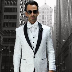 "This Dinner Jacket Tuxedo Is A Modern Cut In A Classic Style. The Fabric Is Elegant White Lace. It Features A One Button Closure, Matching Satin Shawl Lapel, And Side Vents. This Comes In A Modern Fit And Includes The Jacket, Pants, And Matching Vest." White Long Sleeve Three-piece Suit For Semi-formal Events, White Three-piece Long Sleeve Suit For Semi-formal Events, White Single Breasted Blazer For Groom, White Tuxedo-style Party Outerwear, White Tuxedo Style Party Outerwear, White Single Breasted Formal Sets, Single-breasted Wedding Sets For Winter, White Single-breasted Formal Sets, Formal White Single-breasted Set