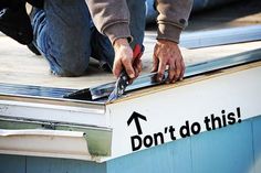 a man is working on the side of a boat with a screwdriver and pliers