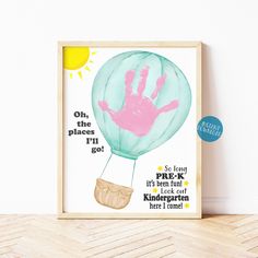 a framed poster with a handprinted hot air balloon in the sky on it