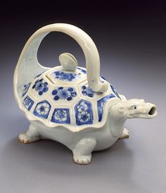 a ceramic tea pot with a tortoise on it