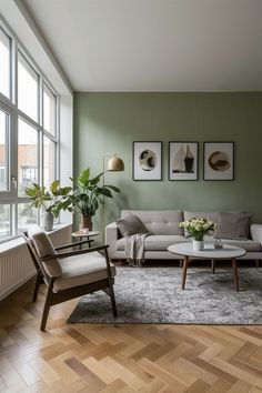 a living room with green walls and wooden floors, two couches and a coffee table