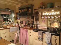 a kitchen filled with lots of clutter and cooking utensils