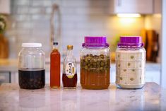 four jars filled with different types of food