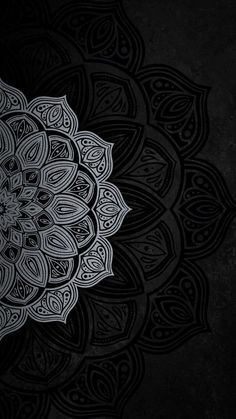 an intricate black and white design on a dark background