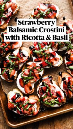 strawberry crostini with balsamic and black olives on a wooden tray