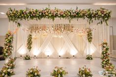 an indoor wedding setup with flowers and greenery