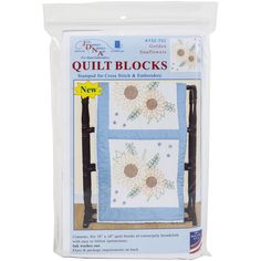 two quilt blocks with sunflowers on the front and back, one in blue