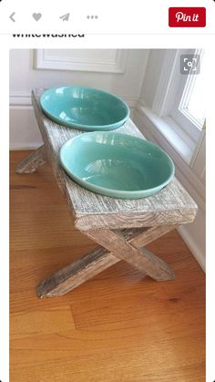 two bowls are sitting on a wooden bench