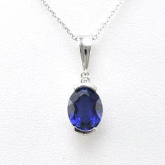 Lab grown sapphire 7x9mm oval cut gemstone is set in a sterling silver pendant setting with a rhodium finish. Rhodium protects the silver from oxidizing quickly as well as gives the appearance of white gold. Cubic zirconia accent enhances the pendant design on the top of the design. Pendant comes on an 18 inch long cable chain. Style Number: 19568 Metal: 925 Sterling Silver Gemstone: Lab Grown Sapphire Dimensions: 13/16 inch long and 1/4 inch wide, 18 inch chain Oval Sapphire Necklace With Hallmark, Classic Sapphire Oval Cabochon Jewelry, Oval Sapphire Necklace With Brilliant Cut, Sapphire Jewelry With Brilliant Cut Oval Pendant, Silver Sapphire Oval Pendant Jewelry, Sapphire Oval Necklace With Diamond Cut, Brilliant Cut Sapphire Oval Pendant, Oval Sapphire Necklace With Diamond Cut, Silver Sapphire Oval Necklace