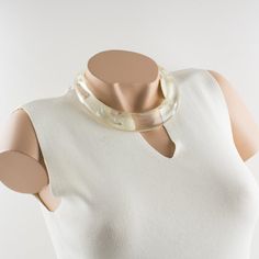 This is part of Chairish’s Costume Jewelry assortment.  An elegant Italian artisan designer studio collar choker necklace.  Lucite or resin rigid bib shape in translucent clear color ornate with silver flakes inclusions in an organic abstract free-form design. Silvered metal chain to adjust the length. No visible maker's mark. Measurements: The inner circumference is 16.57 in (42 cm) - the front height is 1 in (2.6 cm) - the opening is 3.38 in (8.5 cm) - the necklace will fit an average 14.57 in Elegant Resin Necklaces For Party, Clear Lucite Party Jewelry, Elegant Clear Resin Jewelry, White Resin Necklaces, Elegant Resin Jewelry For Wedding, Elegant White Resin Jewelry, Modern White Lucite Jewelry, Adjustable Elegant Resin Necklace, Elegant Lucite Jewelry For Formal Occasions