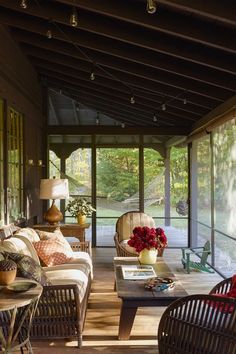 a living room filled with furniture and lots of windows