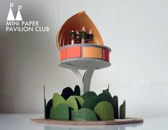 a paper model of a space station on top of trees