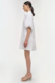 SIGNATURE COLLECTION The Crissy Dress in White. Casual, wear-everywhere shirting inspired mini dress with a relaxed, puffed fit and ballooned short sleeves. Casual Mini Dress, One Piece Clothing, Mini Dress Casual, White Shirt Dress, Mini Shirt Dress, Knitwear Tops, Romper With Skirt, Signature Collection, Shop Swimwear