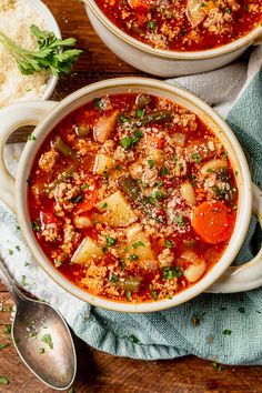 two bowls of vegetable soup on a wooden table