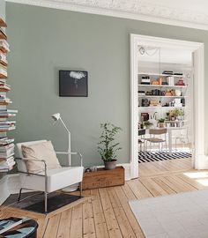 a living room filled with furniture and a clock on the wall