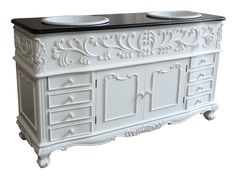 a white cabinet with two bowls on top of it and an ornate design around the drawers