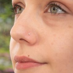 a close up of a woman's face with freckles on her nose