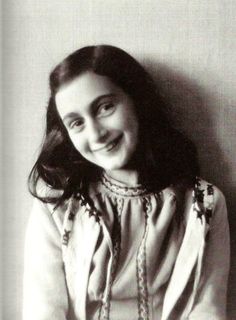 an old black and white photo of a woman smiling