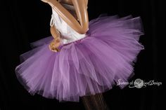 "Make a huge impression with this massive royalty peek a boo style tutu! This tutu is handmade from 35yards of soft smooth Bridal tulle in three layers of light purple that has been gathered and serged to the matching fabric covered elastic waistband. LENGTH 13\" long Measurement: Sizes go by smallest waist size tutu will fit to largest Hips tutu fits over Child size 20\"-30\"inches 12\" long (good for ages 4-13) Adult sizes Please go by your waist size not your hips. Tutu will have plenty of st Purple Tulle Tutu Dress For Wedding, Fitted Lavender Tulle Tutu Dress, Balletcore Fitted Wedding Petticoat, Purple Fitted Tutu Dress With Ruffles, Lavender Princess Style Tutu Dress, Fitted Lavender Princess Tutu Dress, Fitted Princess Style Lavender Tutu Dress, Fairy Style Fitted Tutu Dress With Ruffles, Fitted Princess Style Tulle Petticoat