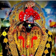 an elaborately decorated headpiece in gold and red