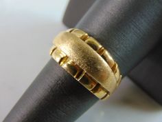 "A WOMENS VINTAGE ESTATE 18K YELLOW GOLD MODERNIST RING. THE TOTAL WEIGHT IS 10.7g AND IS A SIZE 8.25. THE WIDTH OF THE RING IS 3/8\". RING IS STAMPED 750 ON THE INSIDE OF THE BAND. ANY QUESTIONS, PLEASE DON'T HESITATE TO ASK. THIS WOULD MAKE A GREAT GIFT FOR THAT SOMEONE SPECIAL. BE SURE TO CHECK OUT SOME OF OUR OTHER GREAT ITEMS UP FOR SALE. THANK YOU." Heirloom Hallmarked Yellow Gold Wide Band Ring, Vintage Yellow Gold Wide Band Ring For Anniversary, Antique Gold Dome Ring Stamped 14k, Formal Wide Band Dome Ring In Yellow Gold, Formal Yellow Gold Dome Ring With Wide Band, Formal Yellow Gold Wide Band Ring, Gold Dome Ring With 17 Jewels For Wedding, Elegant Yellow Gold Dome Ring For Collectors, Classic Gold Dome Ring Collectible