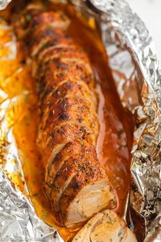 the meat is wrapped in foil and ready to be cooked on the grill or oven