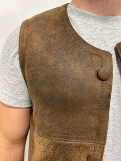 Perfect for three seasons, with the choice to layer on cooler days. Our sheepskin vest are durable, stylish and 100% natural allowing for your body to regulate warm in a productive way. Do you hate how body heat feels from polyester or synthetic fabrics? Then natural sheepskin and wool is the right choice for you. Our rancher vest is made from 100% leather and lined with 100% black mutton sheepskin. Our first model is wearing a size Large, is 6’ 5” and 175 pounds Our second model is wearing a si Leather Winter Outdoor Vest, Rugged Fall Vest Outerwear, Fitted Sleeveless Rugged Outerwear, Rugged Leather Vest Outerwear, Fall Sheepskin Sleeveless Vest, Sleeveless Sheepskin Vest For Fall, Rugged Brown Vest Outerwear, Rugged Fitted Vest Outerwear, Brown Rugged Vest For Winter