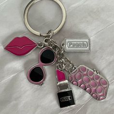 a keychain with lipstick and sunglasses on it