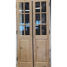 two wooden doors with glass panels on the front and back sides, both side by side