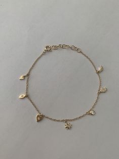 "This dainty yet sturdy charming charm bracelet is the perfect bracelet to layer with other bracelets or just to wear by itself. * 14K Yellow Gold * Approx. Diamond Weight: 0.07cts * Adjustable length: 6\"-7\" *Necklace also available: https://www.etsy.com/listing/510314824/14k-gold-tiny-charm-necklace Upgrades for FedEx/UPS guaranteed 2-day delivery are available and can be selected prior to checkout without separate invoicing. It is generally not an issue, but the USPS cannot guarantee deliver Minimal Charm Bracelet, Bracelet Charms Gold, Cute Everyday Bracelets, Bracelet Dainty, Charm Bracelet Dainty, Gold Bracelet With Charms, Gold Charms For Bracelets, Aesthetic Gold Bracelets, Gold Dainty Charm Bracelet