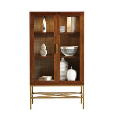 a wooden cabinet with glass doors and white vases on the bottom shelf, against a white background