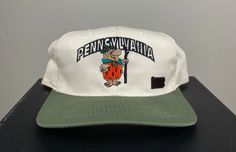 Vintage The Flintstones Pennsylvania Hat Good Condition Made by Annco in China One Size Fits All OSFA *Follow LegacyVintage on Instagram* * I ship all items in two or three business days and utilize Priority Mail options via USPS. Expedited shipping is available upon request. If you have any questions; Please Ask! * All of my items are pre-owned and, unfortunately, sometimes have scuffs, stains, or other signs of pre-lovin'. I will always list any major damage and often will include photos. * I' Vintage Cream Snapback Hat, Swag Hats, Notre Dame University, Future Style, Vintage Cap, Hanna Barbera, Classic American, Sewing Skills, Pennsylvania