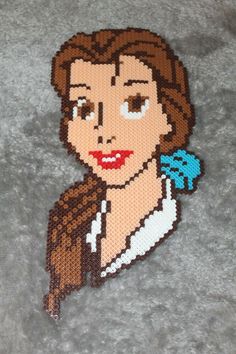 an image of a woman with brown hair and blue eyes on a gray background that is made out of legos