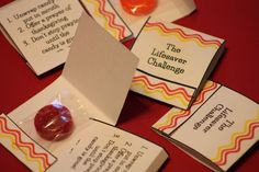 several cards with candy on them sitting next to each other and one has an orange lollipop in it