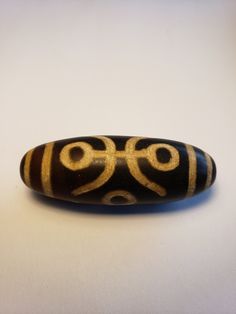 a black and gold object sitting on top of a white table