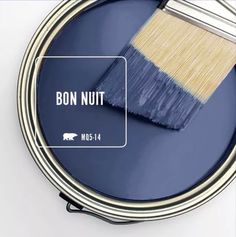 a paint can with a brush in it and the words black garnet on it