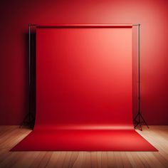 an empty red backdrop stands in front of a wooden floor with a black metal frame