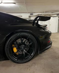 a black sports car parked in a garage