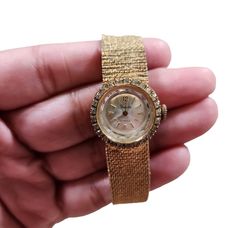 This vintage Sheffield wristwatch is a dazzling addition to any collection. The gold-filled case and band are complemented by rhinestones for a glamorous touch. With 17 jewels, this watch is sure to keep accurate time. The watch is pre-owned but has been well-maintained and is in excellent working condition.  The watch is designed for women and is perfect for formal occasions. The band is 8 inches long and can fit most wrists. This watch is a great find for anyone who loves vintage jewelry. Gold Watches With Diamond Accents For Formal Occasions, Formal Gold Watches With Diamond Accents, Gold Diamond Watch With Accents, Gold Diamond Watch With Diamond Accents, Formal Diamond Watches With Bling, Gold Diamond-accented Watch For Evening, Gold Watches With Diamond Accents For Evening, Gold Evening Watches With Diamond Accents, Gold Diamond Watch With Round Dial