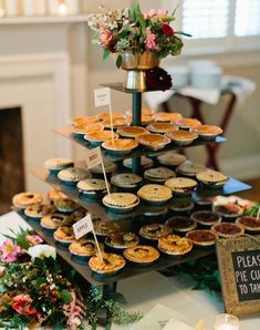 a table topped with lots of pies and cupcakes