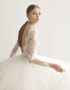 a woman in a white wedding dress with long sleeves and an open back is shown on the instagram page