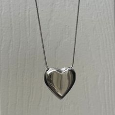 "Puffed Big Heart Necklace in Silver ✨⛓ Fully stainless steel & tarnish proof! 16\" with an extender for adjustability  Snake chain style featuring a silver/chrome puffed heart pendant 🤍 Handmade with love!" Silver Heart Necklace With Adjustable Chain In Stainless Steel, Silver Heart Beads Necklace For Everyday, Silver Stainless Steel Heart Necklace With Adjustable Chain, Everyday Silver Heart Necklace With Heart Beads, Silver Double Heart Stainless Steel Necklace, Silver Stainless Steel Double Heart Necklace, Silver Stainless Steel Heart Necklace, Stainless Steel Heart Necklace For Everyday, Silver Heart Necklace For Everyday