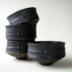 three black bowls stacked on top of each other