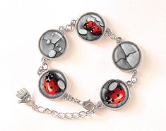 "Handmade bracelet with high quality art print sealed under magnifying glass dome.  *The bracelet* consists of: - 5 silver plated bezels - Magnifying glass domes of 16 mm / 0,63\"  The long of bracelet is adjustable from 17 to 22 cm [6,7\"-8,7\"]. If you need bracelet a little bit longer please let me know during checkout.  ---------------------------------------------------------------------------------------------------------  The matching art print is also available on: *ring, earrings, studs and pendant*.  Each item comes in a velvet gift bag. If You buy a matching set we will pack it in one gift bag.   The item is water resistant but not waterproof. Please take it off before swimming, taking a bath and going to sauna. Not suitable for young children.  --------------------------------- Adjustable Round Bracelets With Cabochon, Adjustable Round Cabochon Bracelet, Nickel-free Silver Glass Bracelet, Silver Metal Bracelet With Cabochon, Silver Round Glass Jewelry, Silver Cabochon Bracelets For Gift, Silver Bracelets With Cabochon For Gift, Handmade Jewelry Display, Ladybug Jewelry