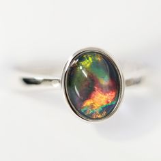 Rhodium Plated Silver Ring-Opal Triplet Modern Oval Opal Ring, Polished Opal Oval Cabochon Ring, Polished Opal Ring In Oval Cabochon Shape, Opal Oval Cabochon Ring With Polished Finish, Modern Opal Ring For Anniversary, Modern Round Opal Ring, Iridescent Opal Ring With Gemstone, Anniversary Oval Cabochon Opal Ring With Polished Finish, Anniversary Opal Ring With Oval Cabochon