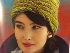 a woman wearing a green knitted hat